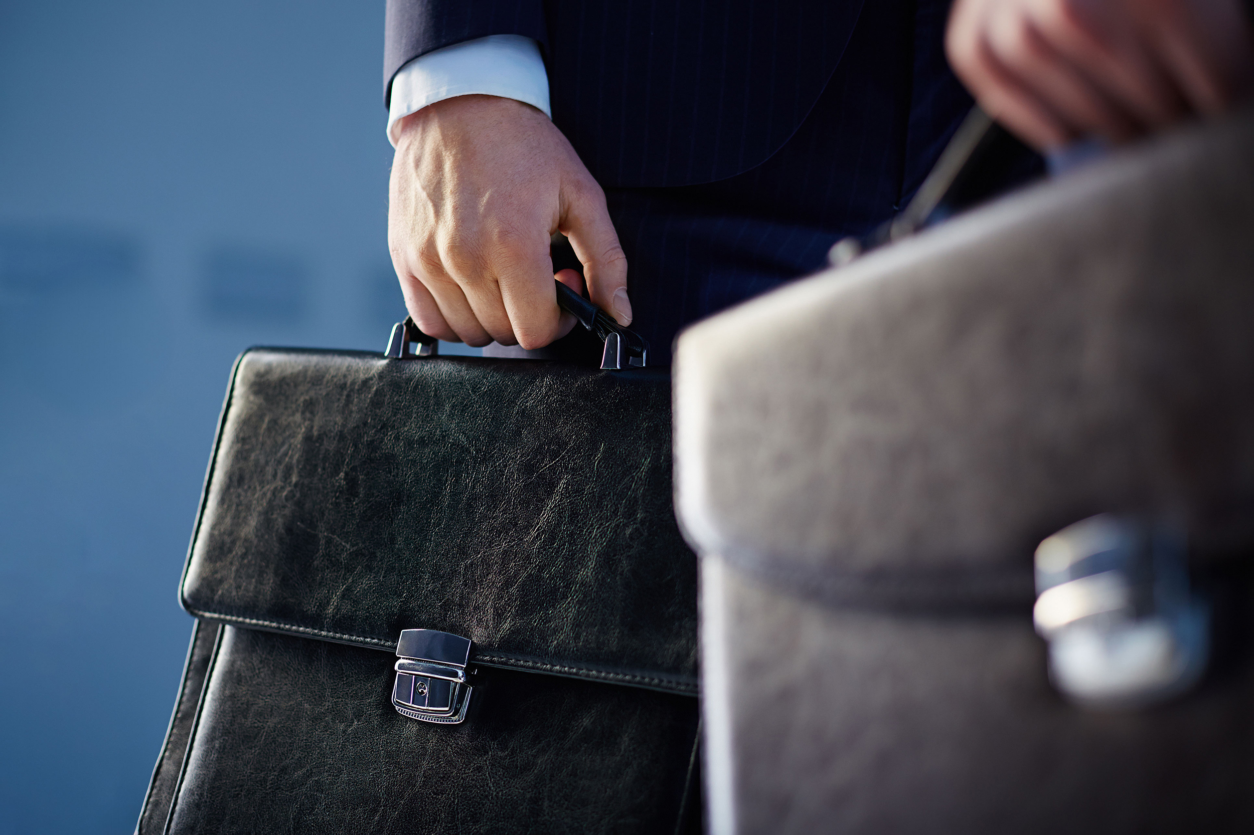 Close up of lawyer's holding briefcases