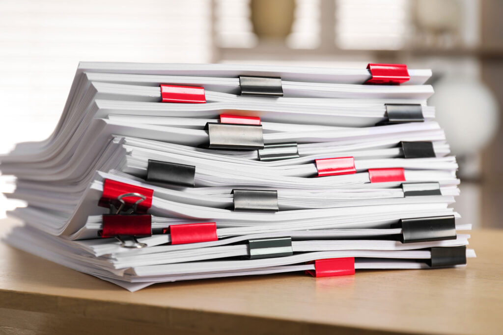 Stack of legal documents with binder clips