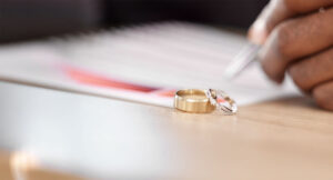 Divorce papers with wedding rings