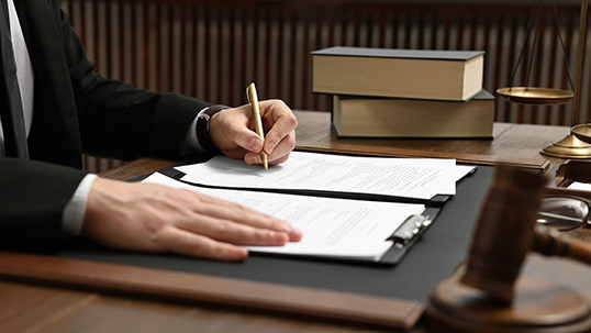 close up of lawyer's hands writing