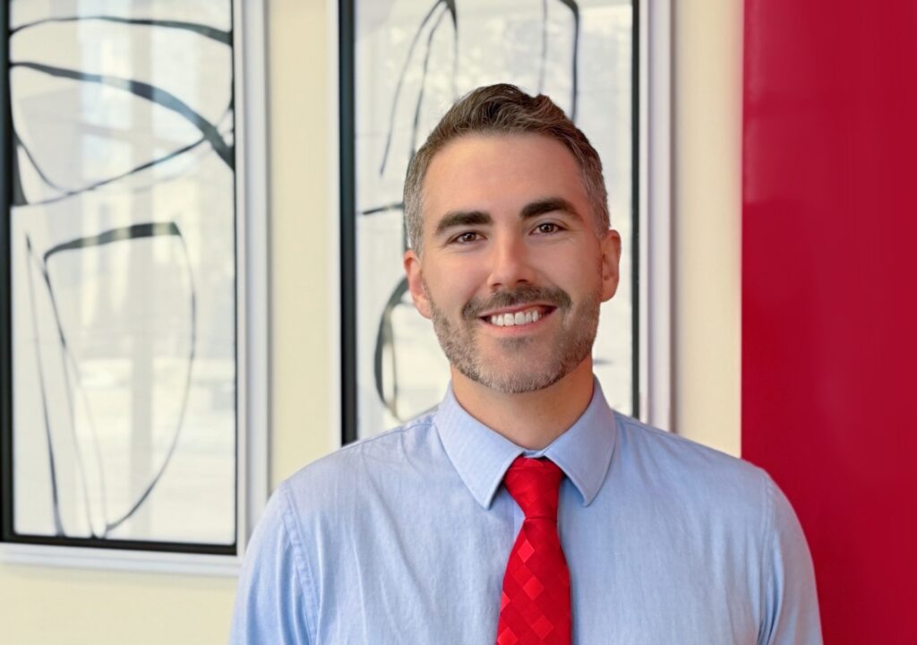 Jordan Jacupke standing in Goosmann office in Sioux City