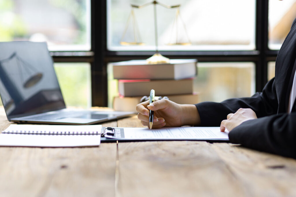Woman taking notes at laptop