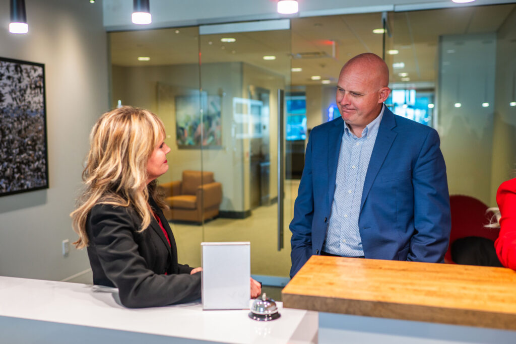 Goosmann team members talking at front desk